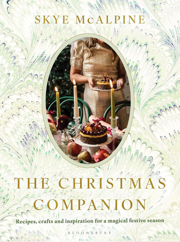 Book cover of 'The Christmas Companion' by Skye McAlpine with a decorative design and photo of a person with candles and a cake.